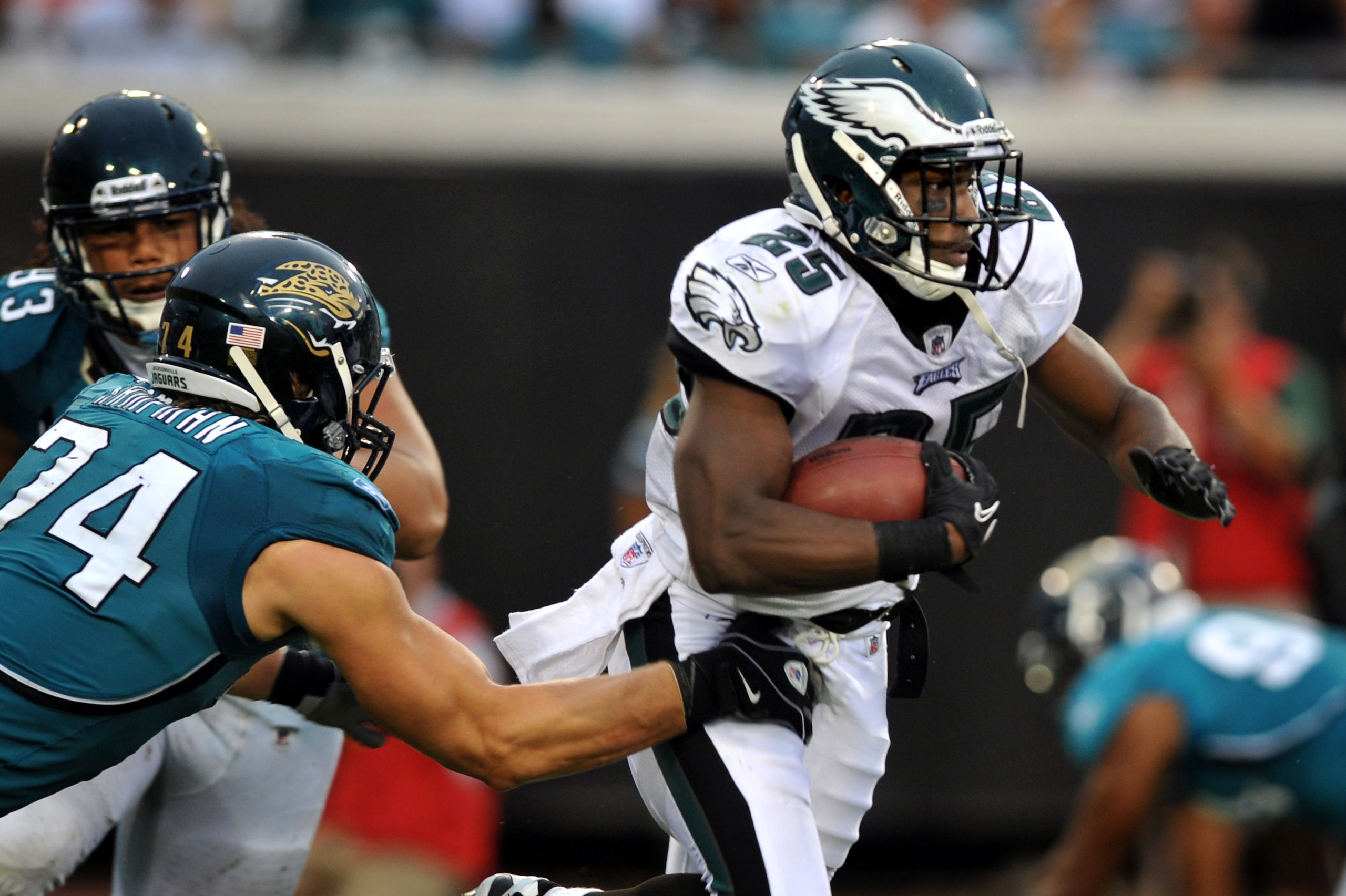 Philadelphia Eagles running back LeSean McCoy (25) eludes a tackle by Jacksonville Jaguars defensive end Aaron Kampman (74) in the third quarter of an NFL football game in Jacksonville, Fla., Sunday, Sept. 26, 2010. Philadelphia beat Jacksonville 28-3. (AP Photo/Stephen Morton)