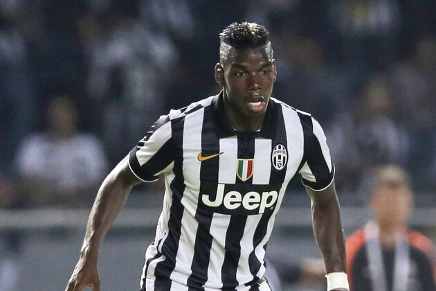 Juventus' Paul Pogba controls the ball during a friendly match against Indonesia Super League All-Starsat Gelora Bung Karno stadium in Jakarta, Indonesia, Wednesday, Aug. 6, 2014. (AP Photo/Dita Alangkara)