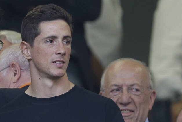 AC Milan forward Fernando Torres of Spain watches from the stands during a Serie A soccer match between AC Milan and Lazio, at the San Siro stadium in Milan, Italy, Sunday, Aug. 31, 2014. (AP Photo/Luca Bruno)