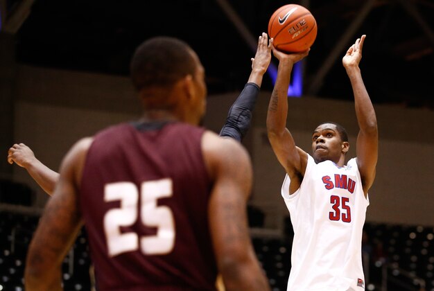 Nov 20, 2013; Garland, TX, USA; Southern Methodist Mustangs center Yanick Moreira (35) shoots against Texas State Bobcats forward Joel Wright (25) during the first half of a NCAA mens basketball game at the Curtis Culwell Center. Mandatory Credit: Jim Cowsert-USA TODAY Sports