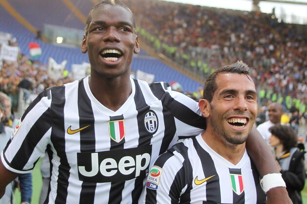 ROME, ITALY - MAY 11: Paul Labile Pogba with Carlos Tevez of Juventus celebrate the victory after the Serie A match between AS Roma and Juventus at Stadio Olimpico on May 11, 2014 in Rome, Italy.  (Photo by Paolo Bruno/Getty Images)