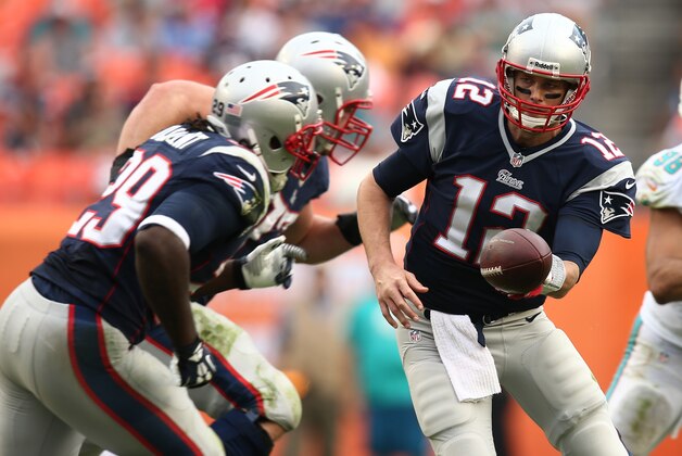 New England Patriots quarterback Tom Brady (12) looks to pass the ball to New England Patriots running back LeGarrette Blount (29) during the second half of an NFL football game against the Miami Dolphins, Sunday, Dec. 15, 2013, in Miami Gardens, Fla. (AP Photo/J Pat Carter)