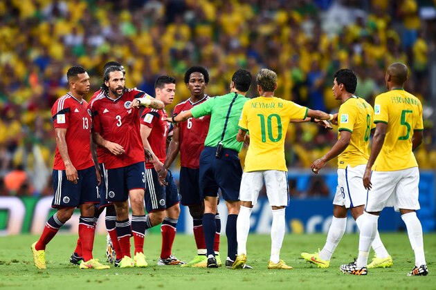 FORTALEZA, BRAZIL - JULY 04: Referee Carlos Velasco Carballo separates James Rodriguez of Colombia and Paulinho of Brazil as teammates look on after a challenge during the 2014 FIFA World Cup Brazil Quarter Final match between Brazil and Colombia at Castelao on July 4, 2014 in Fortaleza, Brazil.  (Photo by Buda Mendes/Getty Images)