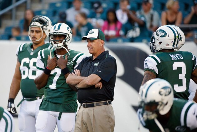 New York Jets head coach Rex Ryan, center, and quarterback Geno Smith (7) watch warm-ups before an NFL preseason football game against the Philadelphia Eagles, Thursday, Aug. 28, 2014, in Philadelphia. (AP Photo/Chris Szagola)