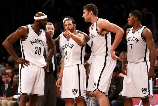 May 4, 2013; Brooklyn, NY, USA; Brooklyn Nets point guard Deron Williams (8) speaks with power forward Reggie Evans (30), center Brook Lopez (11) and shooting guard Joe Johnson (7) during a time out against the Chicago Bulls in game seven of the first round of the 2013 NBA Playoffs at the Barclays Center. Bulls win 99-93. Mandatory Credit: Debby Wong-USA TODAY Sports