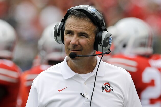 Ohio State head coach Urban Meyer walks on the field in the second half of an NCAA college football game against Navy in Baltimore, Saturday, Aug. 30, 2014. (AP Photo/Patrick Semansky)