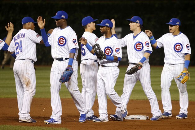 The Chicago Cubs celebrate the team's 7-1 win over the Milwaukee Brewers after a baseball game Tuesday, Sept. 2, 2014, in Chicago. (AP Photo/Charles Rex Arbogast)