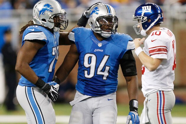 DETROIT, MI - DECEMBER 22:  Ezekiel Ansah #94 of the Detroit Lions celebrate a second quarter sack of Eli Manning #10 of the New York Giants with Willie Young #79 at Ford Field on December 22, 2013 in Detroit, Michigan. (Photo by Gregory Shamus/Getty Images)