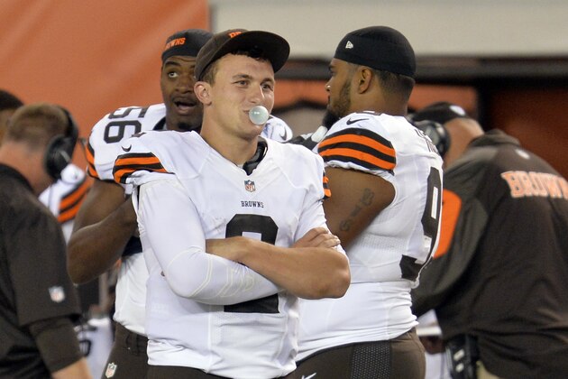 Cleveland Browns quarterback Johnny Manziel blows a bubble on the sidelines on the fourth quarter of a preseason NFL football game against the Chicago Bears Thursday, Aug. 28, 2014, in Cleveland. (AP Photo/David Richard)