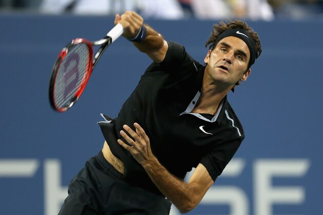 NEW YORK, NY - SEPTEMBER 02:  Roger Federer of Switzerland serves to Roberto Bautista Agut of Spain during their men's singles fourth round match on Day Nine of the 2014 US Open at the USTA Billie Jean King National Tennis Center on September 2, 2014 in the Flushing neighborhood of the Queens borough of New York City.  (Photo by Matthew Stockman/Getty Images)