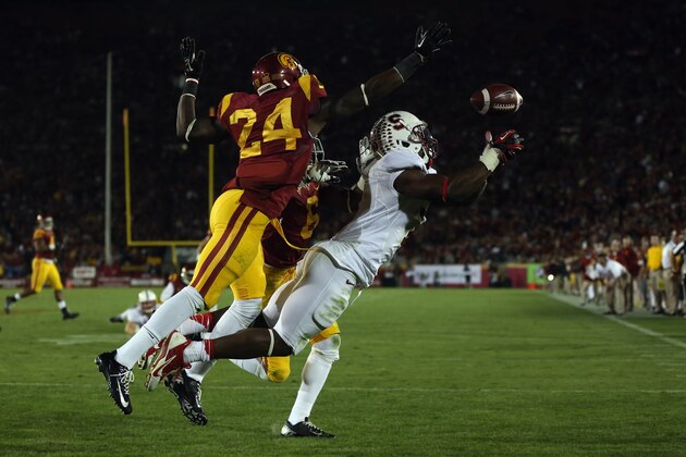 LOS ANGELES, CA - NOVEMBER 16:  Wide receiver Ty Montgomery #7 of the Stanford Cardinal lunges but can't make a reception while defended by Demetrius Wright #24 of the USC Trojans in the second half at Los Angeles Coliseum on November 16, 2013 in Los Angeles, California. USC defeated Stanford 20-17.  (Photo by Jeff Gross/Getty Images)