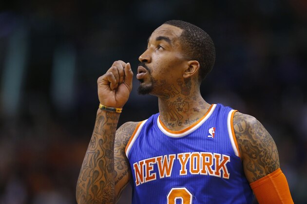 New York Knicks'  J.R. Smith looks at the scoreboard during the second half of an NBA basketball game against the Phoenix Suns, Friday, March 28, 2014, in Phoenix. The Suns won 112-88. (AP Photo/Matt York)