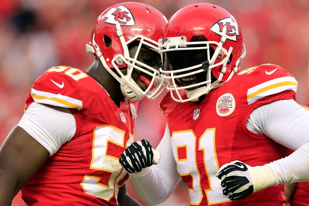 KANSAS CITY, MO - OCTOBER 20:  Outside linebacker Tamba Hali #91 of the Kansas City Chiefs is congratulated by outside linebacker Justin Houston #50 after sacking quarterback Case Keenum #7 of the Houston Texans late in the 2nd half of the game at Arrowhead Stadium on October 20, 2013 in Kansas City, Missouri.  (Photo by Jamie Squire/Getty Images)