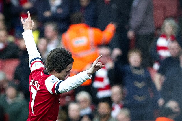 Arsenal's Tomas Rosicky, raises his arms after scoring against Sunderland, during their English Premier League soccer match, at the Emirates Stadium, in London, Saturday, Feb. 22, 2014. (AP Photo/Bogdan Maran)