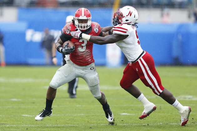 JACKSONVILLE, FL - JANUARY 1: Todd Gurley #3 of the Georgia Bulldogs runs the ball in the first half against Jason Ankrah #9 of the Nebraska Cornhuskers during the TaxSlayer.com Gator Bowl at Everbank Field on January 1, 2014 in Jacksonville, Florida. (Photo by Joe Robbins/Getty Images)