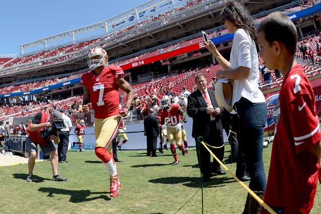 SANTA CLARA, CA - AUGUST 24:  Quarterback Colin Kaepernick #7 of the San Francisco 49ers runs onto the field before the preseason game against the San Diego Chargers at Levi's Stadium on August 24, 2014 in Santa Clara, California.  (Photo by Noah Graham/Getty Images)