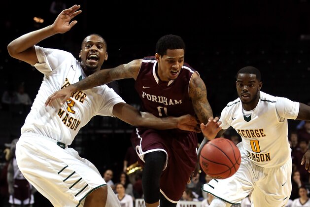 NEW YORK, NY - MARCH 12: Branden Frazier #0 of the Fordham Rams handles the ball against Johnny Williams #2 and Bryon Allen #0 of the George Mason Patriots in the first half during the first round of the Atlantic 10 Men's Basketball Tournament at Barclays Center on March 12, 2014 in the Brooklyn Borough of New York City.  (Photo by Mike Lawrie/Getty Images)