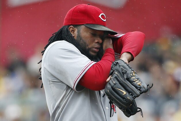 Cincinnati Reds starting pitcher Johnny Cueto wipes his face after giving up a leadoff solo home run to Pittsburgh Pirates' Josh Harrison during the first inning of a baseball game against the Pittsburgh Pirates in Pittsburgh, Sunday, Aug. 31, 2014. (AP Photo/Gene J. Puskar)