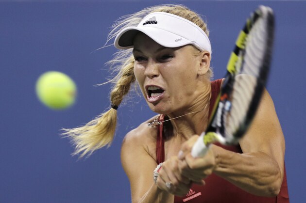 Caroline Wozniacki, of Denmark, returns to Sara Errani, of Italy, during the quarterfinal round of the 2014 U.S. Open tennis tournament, Tuesday, Sept. 2, 2014, in New York. (AP Photo/Charles Krupa)