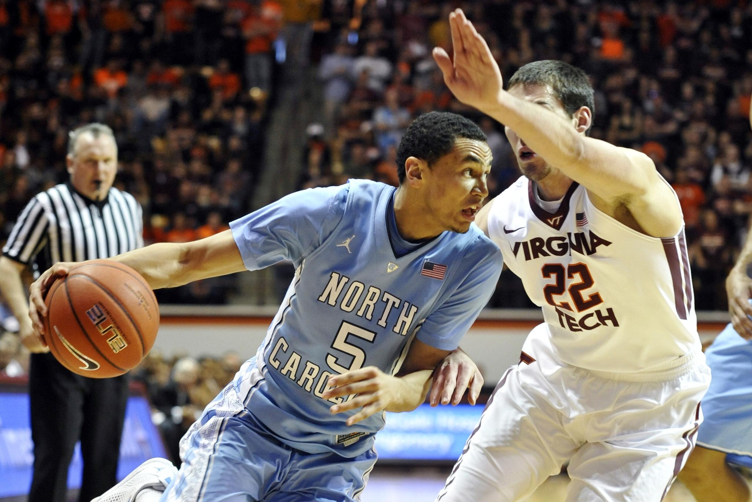 Mar 1, 2014; Blacksburg, VA, USA; North Carolina Tar Heels guard Marcus Paige (5) dribbles past Virginia Tech Hokies forward Christian Beyer (22) in the first half at Cassell Coliseum. Mandatory Credit: Michael Shroyer-USA TODAY Sports