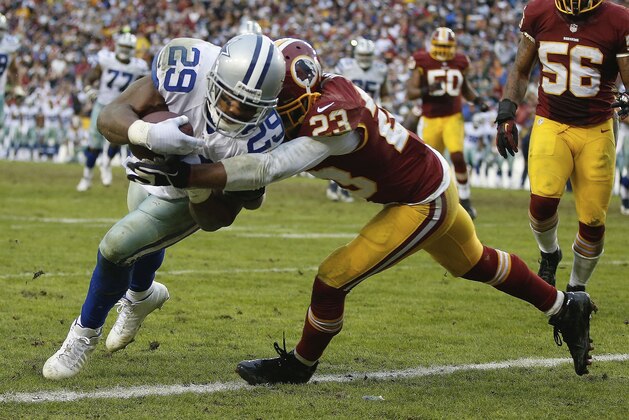 Dallas Cowboys running back DeMarco Murray carries the ball into the end zone for a touchdown late in the fourth quarter under pressure from Washington Redskins cornerback DeAngelo Hall during an NFL football game in Landover, Md., Sunday, Dec. 22, 2013. The Cowboys defeated the Redskins 24-23. (AP Photo/Evan Vucci)