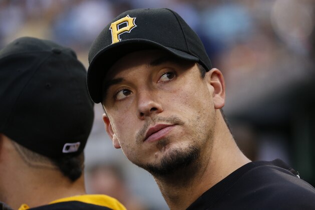 Pittsburgh Pirates starting pitcher Charlie Morton stands in the dugout during the third inning of a baseball game against the San Diego Padres in Pittsburgh Friday, Aug. 8, 2014. (AP Photo/Gene J. Puskar)