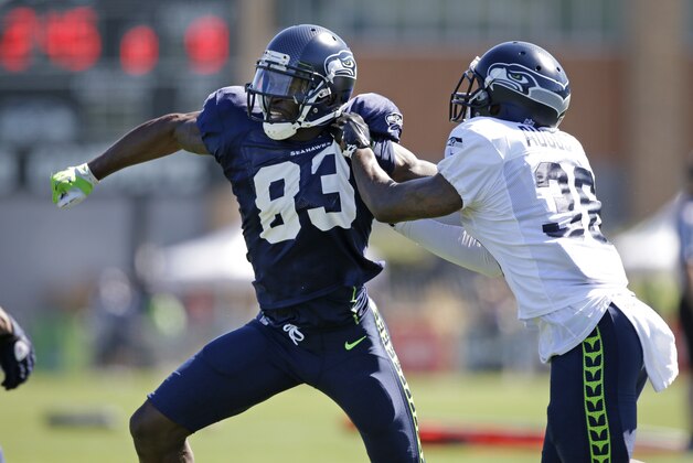 Seattle Seahawks' Ricardo Lockette (83) tries to get past Akeem Auguste during a drill at an NFL football camp practice Wednesday, July 30, 2014, in Renton, Wash. (AP Photo/Elaine Thompson)