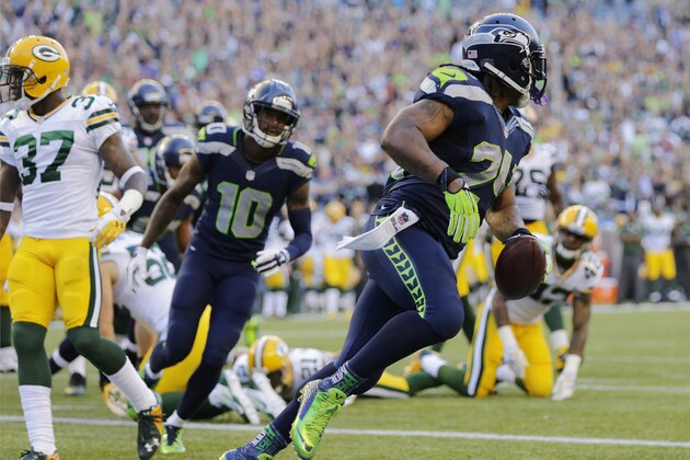 Seattle Seahawks' Marshawn Lynch, right, scores a touchdown in the first half of an NFL football game against the Green Bay Packers, Thursday, Sept. 4, 2014, in Seattle. (AP Photo/Scott Eklund)