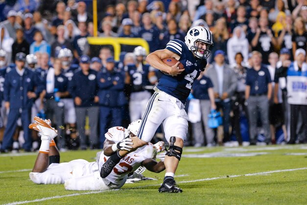 Sep 7, 2013; Provo, UT, USA; Brigham Young Cougars quarterback Taysom Hill (4) drags Texas Longhorns linebacker Steve Edmond (33) during the second quarter at Lavell Edwards Stadium. Mandatory Credit: Chris Nicoll-USA TODAY Sports