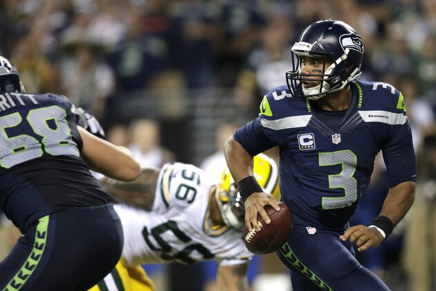 Seattle Seahawks quarterback Russell Wilson looks to pass in the second half of an NFL football game against the Green Bay Packers, Thursday, Sept. 4, 2014, in Seattle. The Seahawks defeated the Packers 36-16. (AP Photo/Scott Eklund)