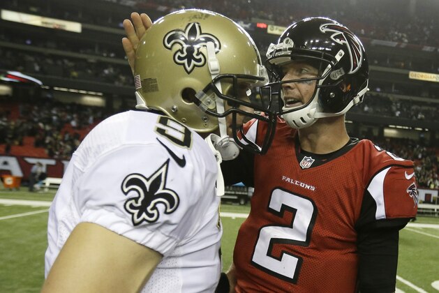 New Orleans Saints quarterback Drew Brees (9) speaks with Atlanta Falcons quarterback Matt Ryan (2) after the second half of an NFL football game, Thursday, Nov. 21, 2013, in Atlanta. The New Orleans Saints won 17-13. (AP Photo/David Goldman)