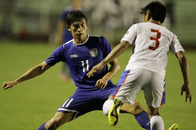 The Philippines' Daisuke Sato (3) and Taiwan's Li Mao (11) battle for the ball during the Peace Cup 2014 soccer friendly match Wednesday, Sept.3, 2014 at the rain-soaked Rizal Memorial Football Stadium in Manila, Philippines. (AP Photo/Bullit Marquez)