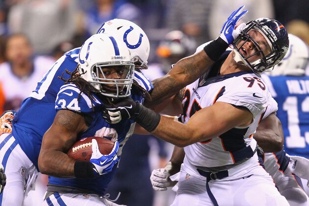 INDIANAPOLIS, IN - OCTOBER 20: Trent Richardson #34 of the Indianapolis Colts looks to escape a tackle by Derek Wolfe #95 of the Denver Broncos at Lucas Oil Stadium on October 20, 2013 in Indianapolis, Indiana.  The Colts beat the Broncos 39-33.  (Photo by Dilip Vishwanat/Getty Images)