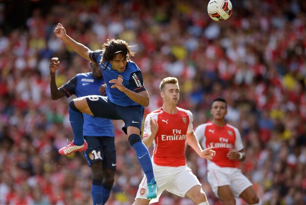 AS Monaco's Radamel Falcao scores a header during the Emirates Cup soccer match between Arsenal and AS Monaco at Arsenal's Emirates Stadium, London, Sunday, Aug. 3, 2014.  (AP Photo/Matt Dunham)
