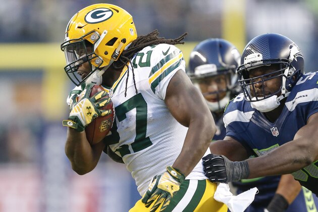 Sep 4, 2014; Seattle, WA, USA; Green Bay Packers running back Eddie Lacy (27) breaks a tackle by Seattle Seahawks defensive end Cliff Avril (56) during the third quarter at CenturyLink Field. Mandatory Credit: Joe Nicholson-USA TODAY Sports