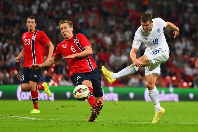 LONDON, ENGLAND - SEPTEMBER 03:  James Milner of England shoots past Stefan Johansen of Norway during the International friendly match between England and Norway at Wembley Stadium on September 3, 2014 in London, England.  (Photo by Laurence Griffiths/Getty Images)