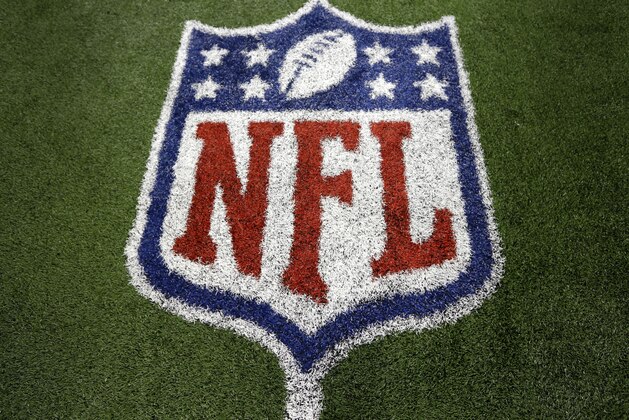 An NLF logo marks the turf on the field after a football game between the Washington Redskins and Dallas Cowboys Sunday, Oct. 13, 2013, in Arlington, Texas. (AP Photo/LM Otero)