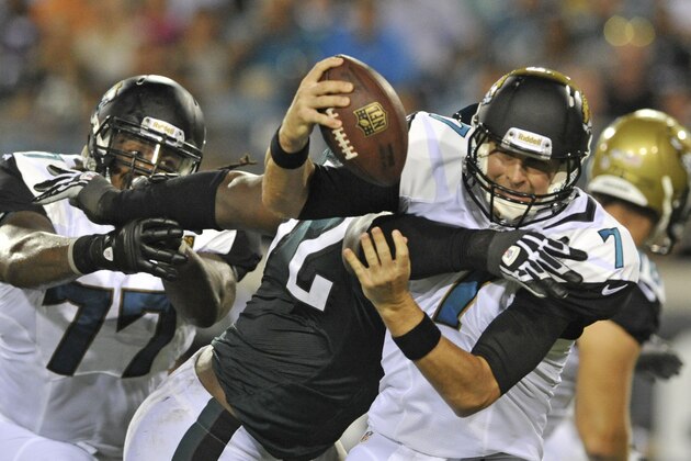 Jacksonville Jaguars quarterback Chad Henne, right, is sacked by Philadelphia Eagles tackle Michael Bamiro, center, as he gets past guard Uche Nwaneri (77) during the first half of an NFL preseason football game, Saturday, Aug. 24, 2013, in Jacksonville, Fla. (AP Photo/Stephen Morton)