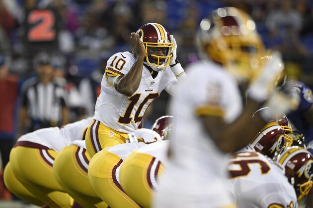 Washington Redskins quarterback Robert Griffin III (10) prepares to run a play in the first half of an NFL preseason football game against the Baltimore Ravens, Saturday, Aug. 23, 2014, in Baltimore. (AP Photo/Nick Wass)