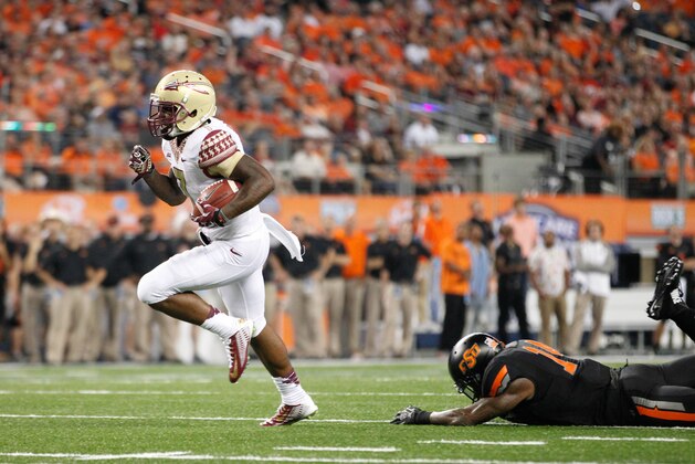 Aug 30, 2014; Arlington, TX, USA; Florida State Seminoles running back Mario Pender (7) runs the ball in the game against the Oklahoma State Cowboys at AT&T Stadium. Florida State beat Oklahoma State 37-31. Mandatory Credit: Tim Heitman-USA TODAY Sports