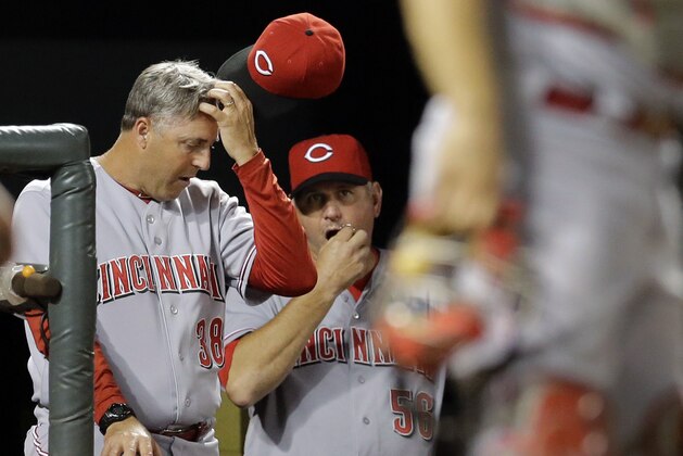 Cincinnati Reds manager Bryan Price, left, and pitching coach Jeff Pico stand in the dugout in the seventh inning of an interleague baseball game against the Baltimore Orioles, Wednesday, Sept. 3, 2014, in Baltimore. Baltimore won 6-0. (AP Photo/Patrick Semansky)