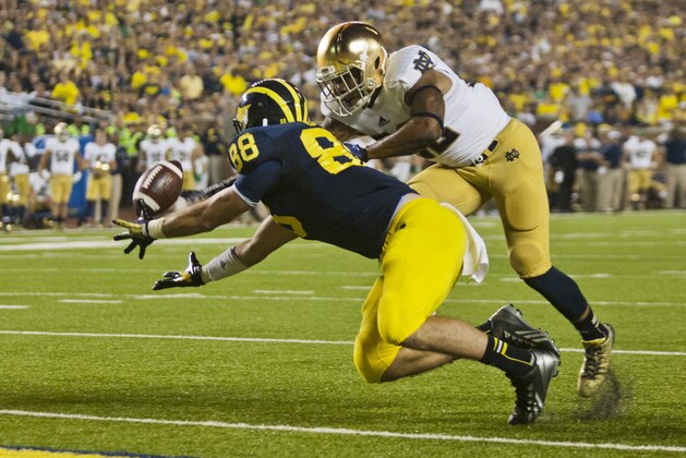 Michigan tight end Jake Butt (88) has his touchdown reception broken up by Notre Dame safety Elijah Shumate in the fourth quarter of an NCAA college football game, in Ann Arbor, Mich., Saturday, Sept. 7, 2013. Notre Dame was penalized for pass interference on the play and Michigan later won the game 41-30. (AP Photo/Tony Ding)