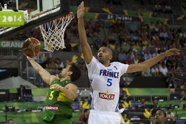 Brazil's Raul Togni Neto, left, shoots over France's Nicolas Batum, during the Group A Basketball World Cup match between Brazil and France in Granada, Spain, Saturday, Aug. 30, 2014. The 2014 Basketball World Cup competition will take place in various cities in Spain from Aug. 30 through to Sept. 14. (AP Photo/Daniel Tejedor)