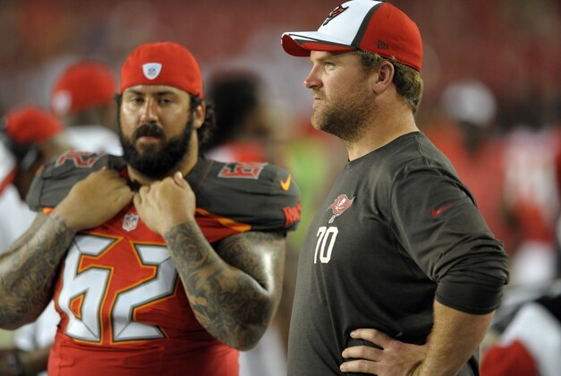 New Tampa Bay Buccaneers guard Logan Mankins (70) talks to center Evan Dietrich-Smith (62) during the fourth quarter of an NFL preseason football game Thursday, Aug. 28, 2014, in Tampa, Fla. (AP Photo/Steve Nesius)