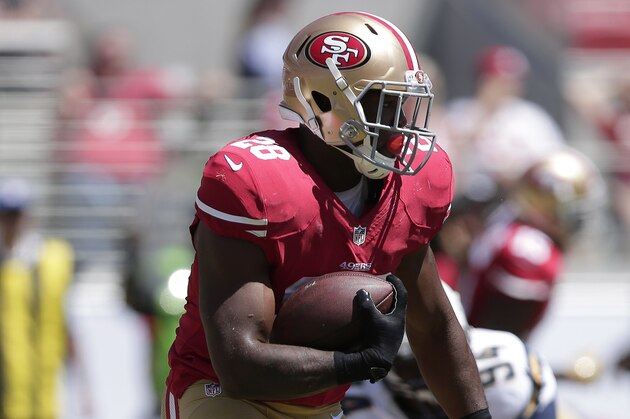 San Francisco 49ers running back Carlos Hyde (28) runs against the San Diego Chargers during the first quarter of an NFL preseason football game in Santa Clara, Calif., Sunday, Aug. 24, 2014. (AP Photo/Marcio Jose Sanchez)