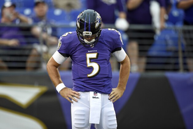 Baltimore Ravens quarterback Joe Flacco pauses as he warms up before an NFL preseason football game against the Washington Redskins, Saturday, Aug. 23, 2014, in Baltimore. (AP Photo/Nick Wass)