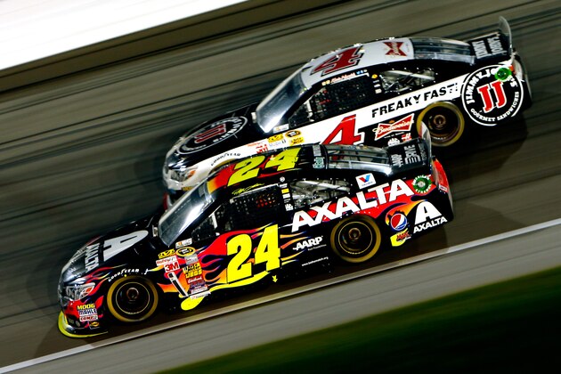 KANSAS CITY, KS - MAY 10:  Jeff Gordon, driver of the #24 Axalta Coatings Chevrolet, races Kevin Harvick, driver of the #4 Jimmy John's Chevrolet, during the NASCAR Sprint Cup Series 5-Hour Energy 400 at Kansas Speedway on May 10, 2014 in Kansas City, Kansas.  (Photo by Kyle Rivas/Getty Images)