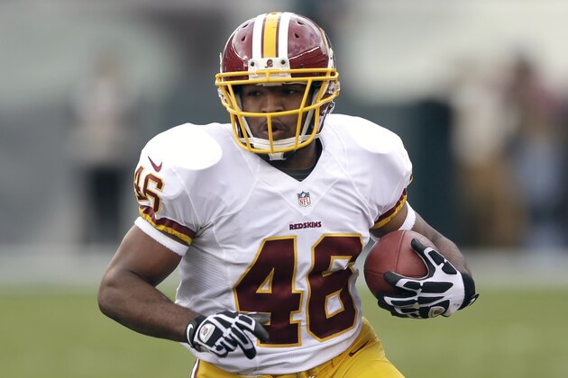 Washington Redskins running back Alfred Morris carries the ball during the first half of an NFL football game against Philadelphia Eagles in Philadelphia Sunday, Nov. 17, 2013. (AP Photo/Matt Rourke)