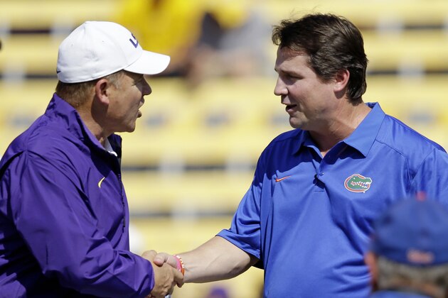 LSU head coach Les Miles, left, shakes hands with Florida head coach Will Muschamp before an NCAA college football game in Baton Rouge, La., Saturday, Oct. 12, 2013. (AP Photo/Gerald Herbert)