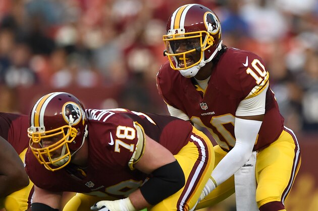 LANDOVER, MD - AUGUST 07: Quarterback Robert Griffin III #10 of the Washington Redskins takes a snap against the New England Patriots during a preseason NFL game at FedExField on August 7, 2014 in Landover, Maryland. The Washington Redskins won, 23-6. (Photo by Patrick Smith/Getty Images)